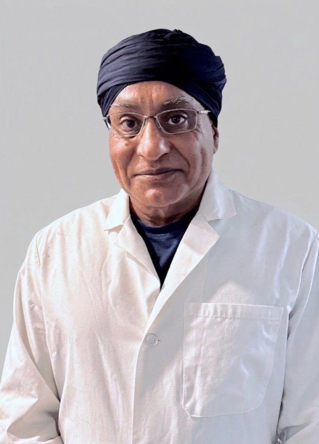Dr. Gurpreet Singh Padda, MD, MBA, MHP, in a white coat at the Gateway Midwest Healthcare clinic